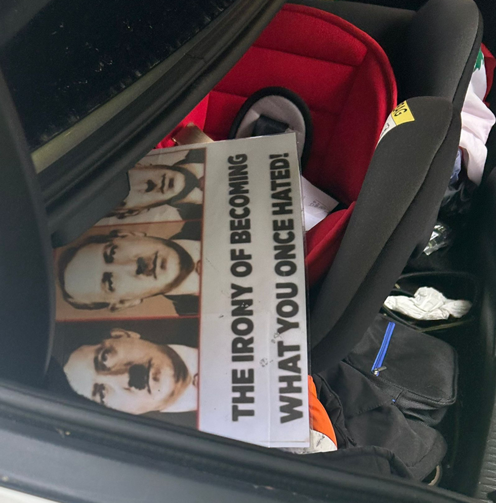 Placards with Hitler's face on were discovered in the boot of a Palestinian protester's car