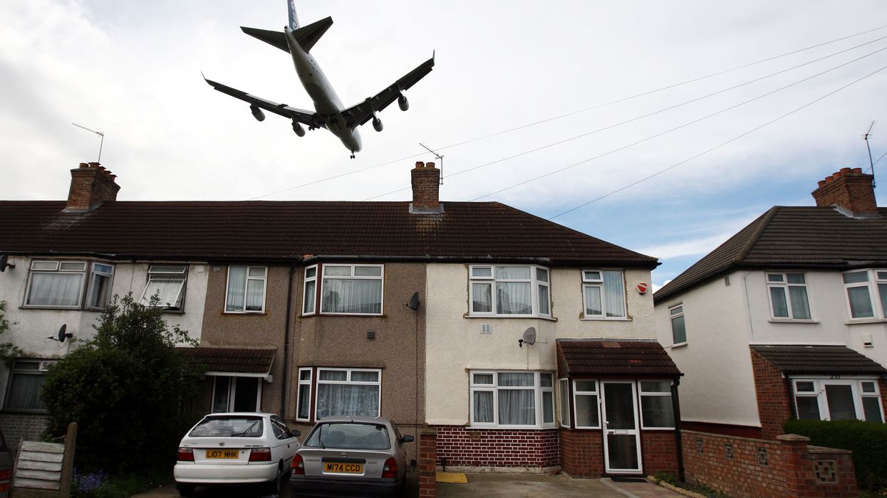 Plane flying low over a house