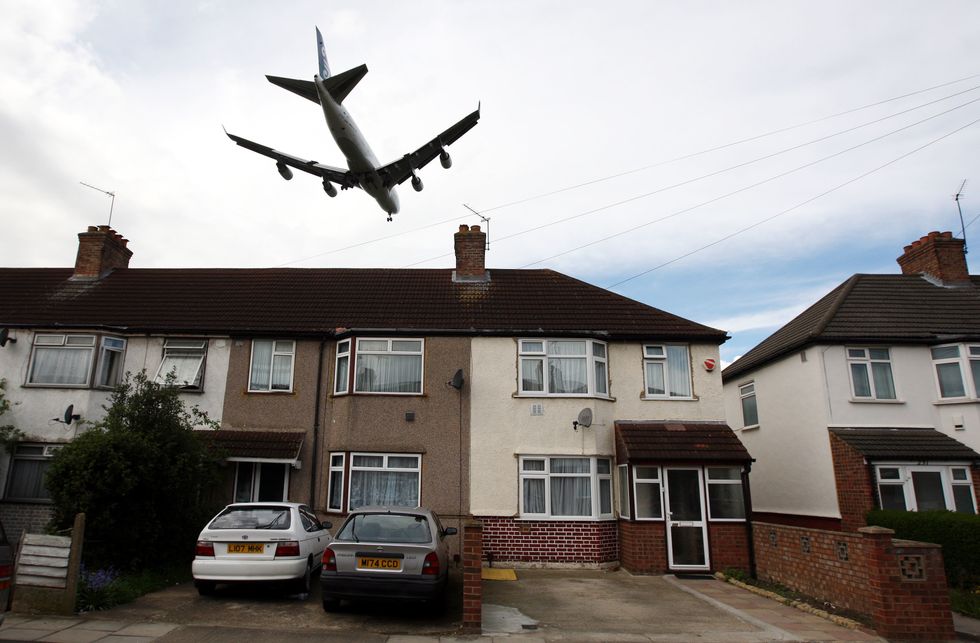 Plane flying low over a house