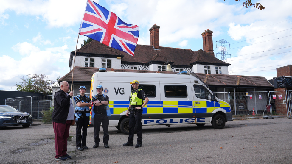 Police and a protester outside the Bell Hotel