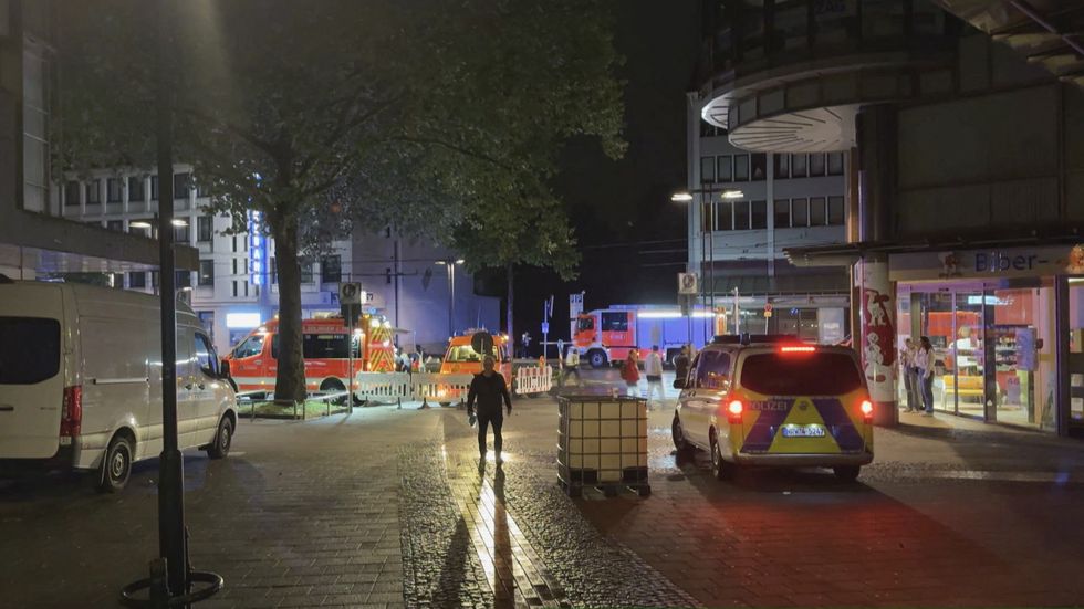 Police and ambulances stand near the scene