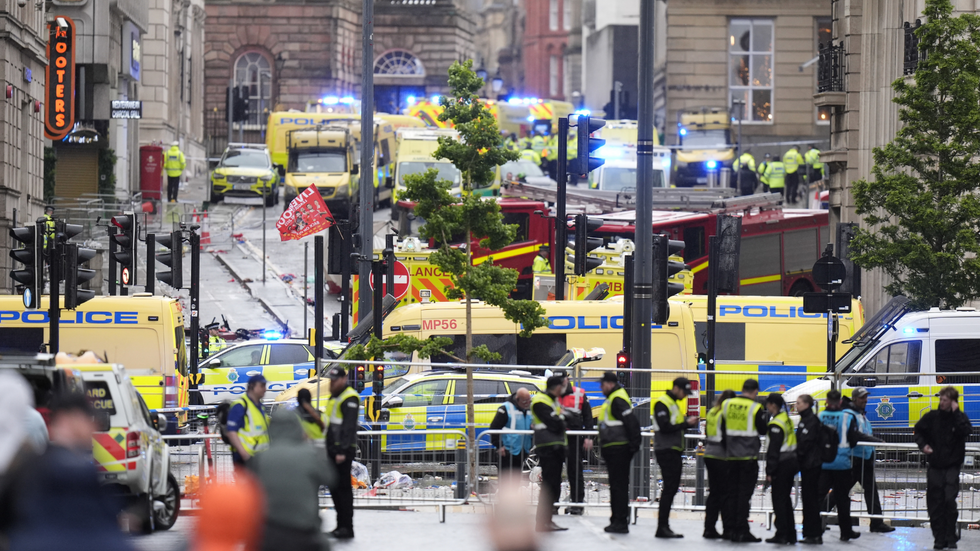 Police and emergency personnel deal with the aftermath of the Liverpool car ramming
