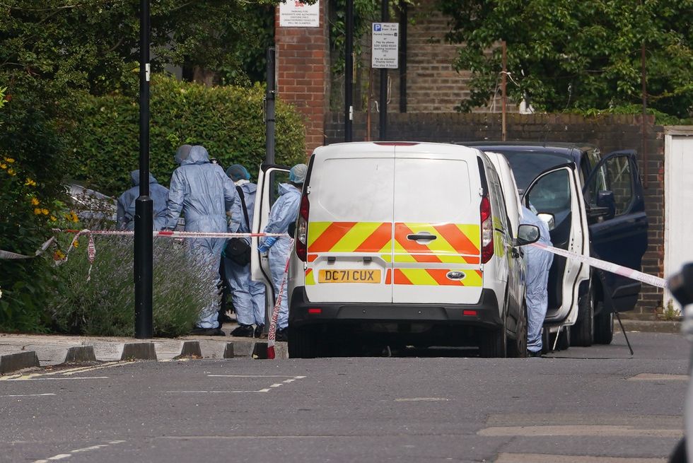 Police and forensic officers and at an address in Shepherd's Bush
