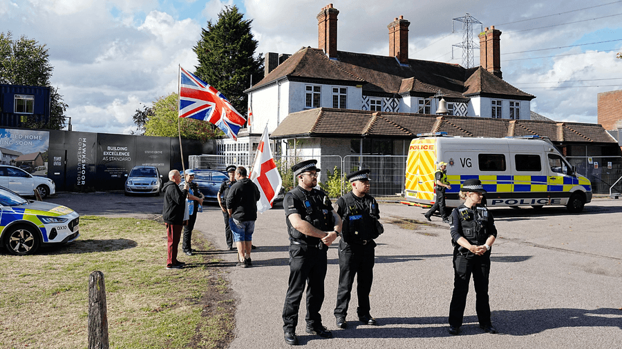 Police and protesters outside the Bell Hotel