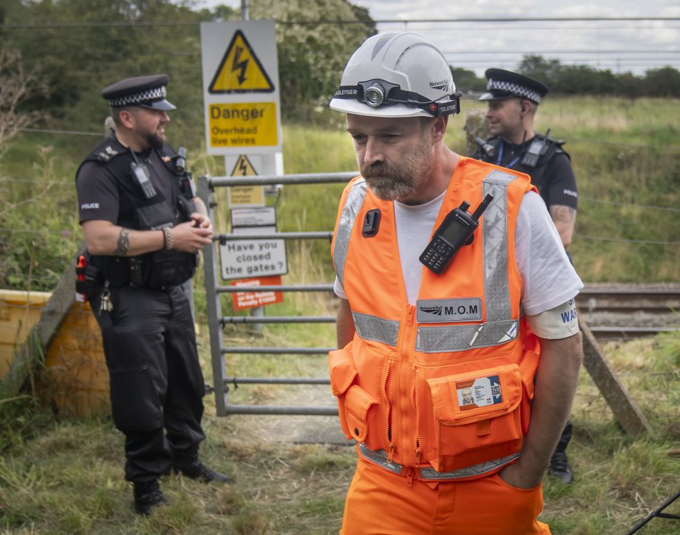 Police and railway workers near the scene in Balderton, near Newark-on-Trent
