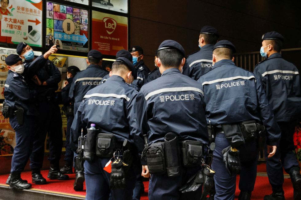 Police are seen outside the Stand News office building, after six people were arrested %22for conspiracy to publish seditious publication%22 according to Hong Kong's Police National\u00a0Security\u00a0Department,\u00a0in Hong Kong, China, December 29, 2021. REUTERS/Tyrone Siu