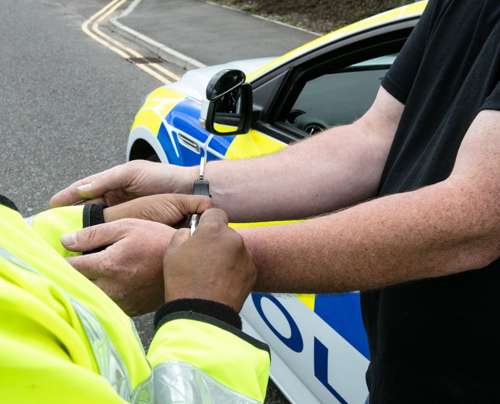 Police arresting man