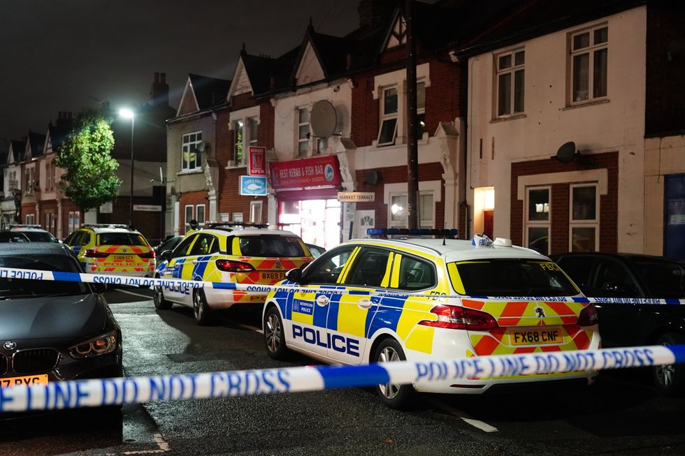 Police at the scene in Albany Parade in Brentford, where a man has been killed and a pensioner is in a critical condition in hospital after they were stabbed in a street in west London.
