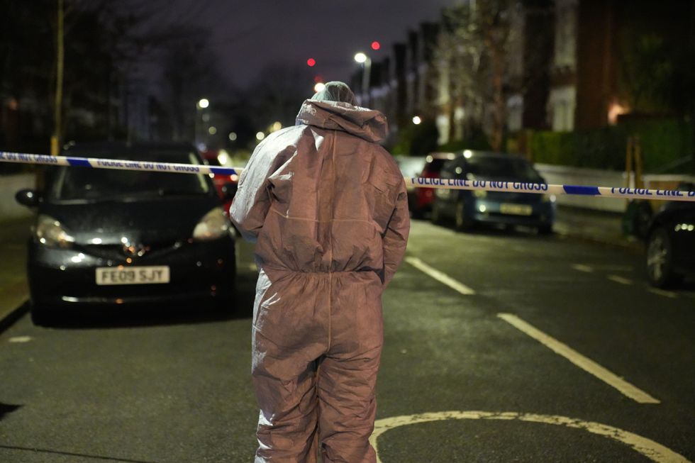 Police at the scene of an incident near Clapham Common, south London, after a suspected corrosive substance was thrown at a woman and her two young children
