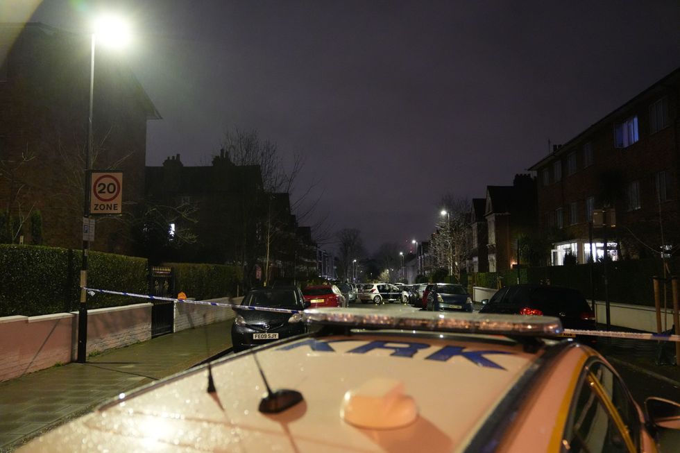 Police at the scene of an incident near Clapham Common, south London, after a suspected corrosive substance was thrown at a woman and her two young children