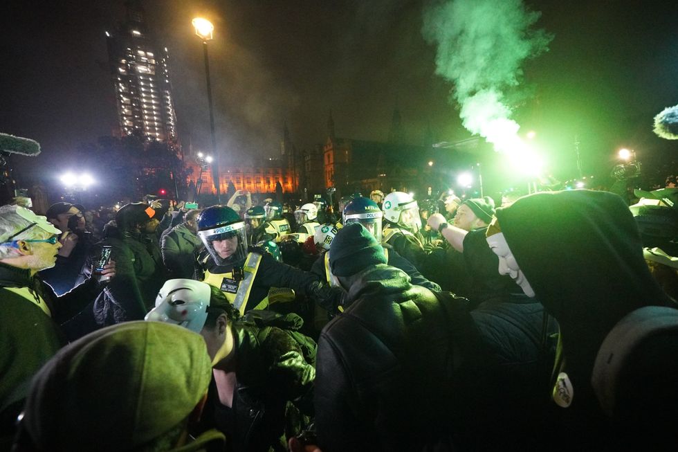 Police clash with protesters as they take part in the Million Mask March 2021 in Parliament Square, London. Picture date: Friday November 5, 2021.
