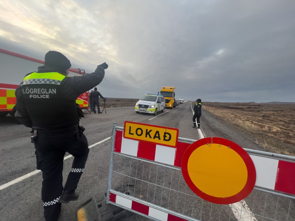 Police direct traffic out of Grindavik on November 14, 2023