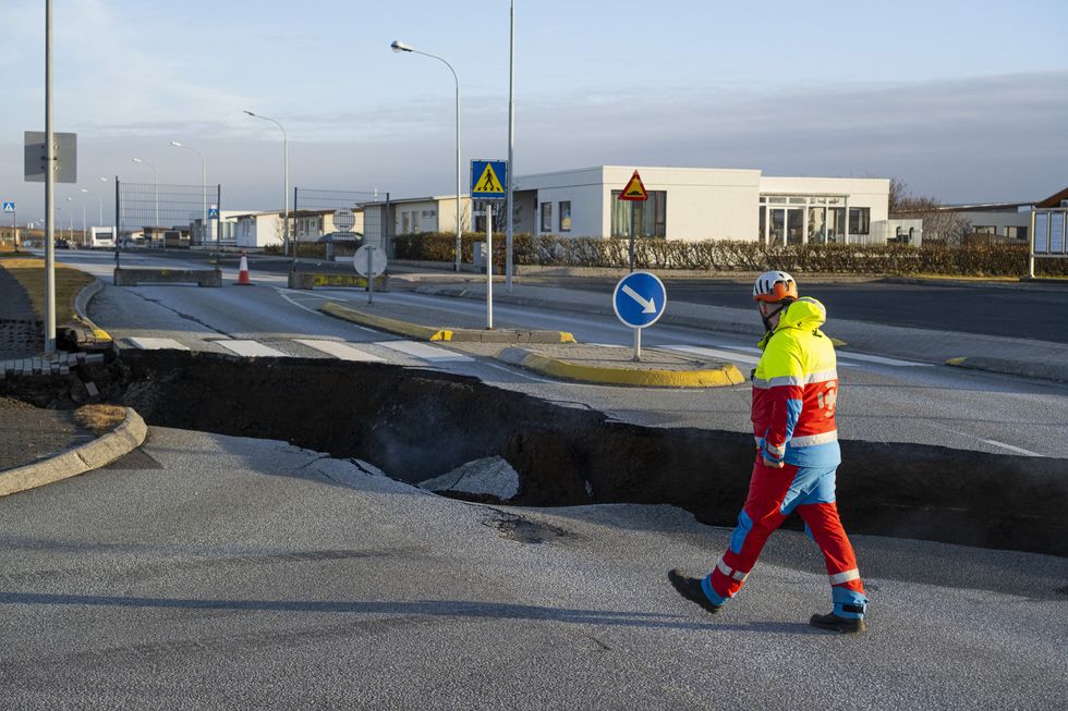 Police direct traffic out of Grindavik on November 14, 2023