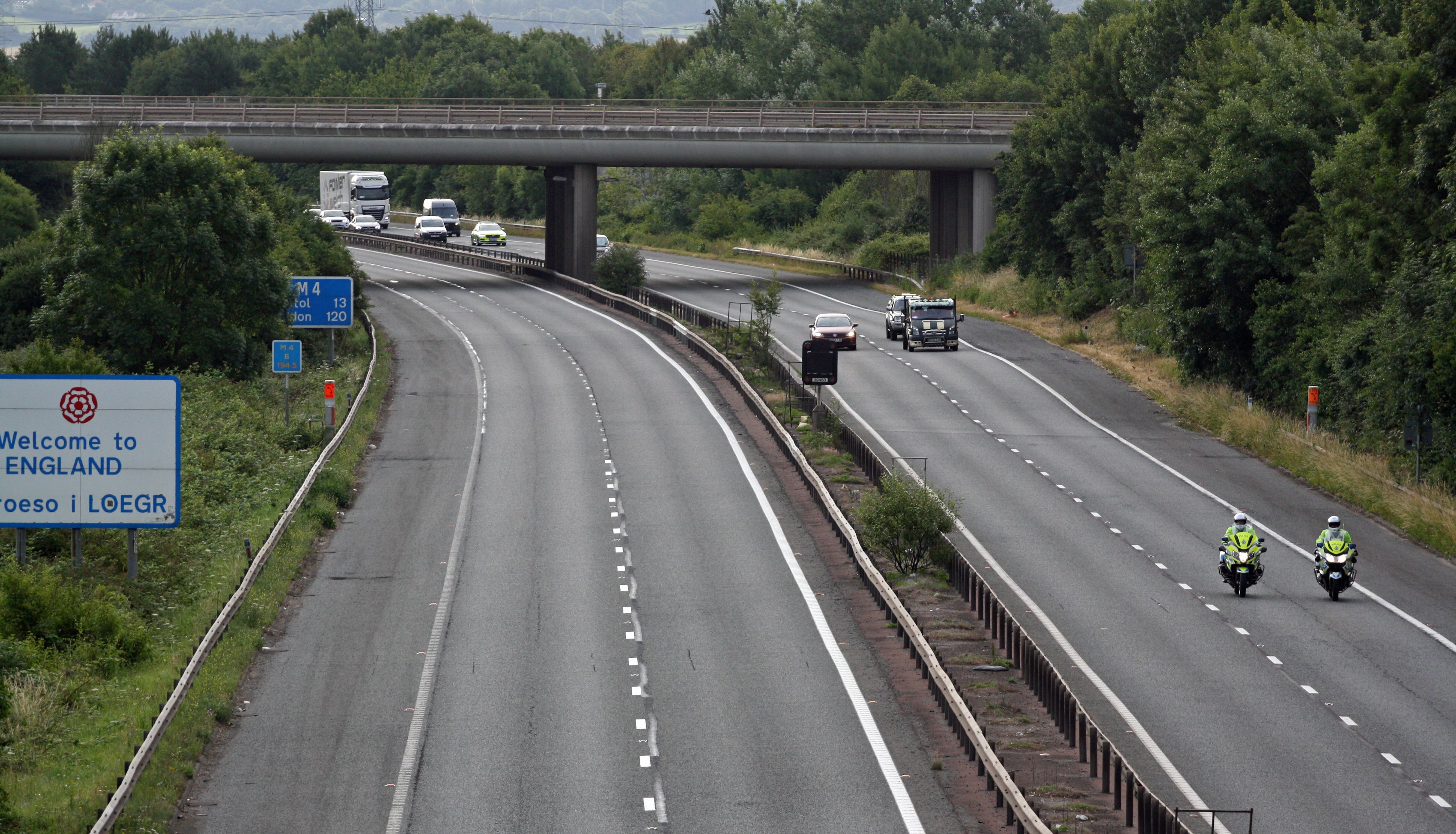 Police escort vehicles along the M4 motorway during the morning rush hour as drivers hold a go-slow protest on the M4. Police have warned of %22serious disruption throughout the day%22 as protesters target motorways in a demonstration over high fuel prices. The protests are understood to be organised via social media under the banner Fuel Price Stand Against Tax. Picture date: Monday July 4, 2022.