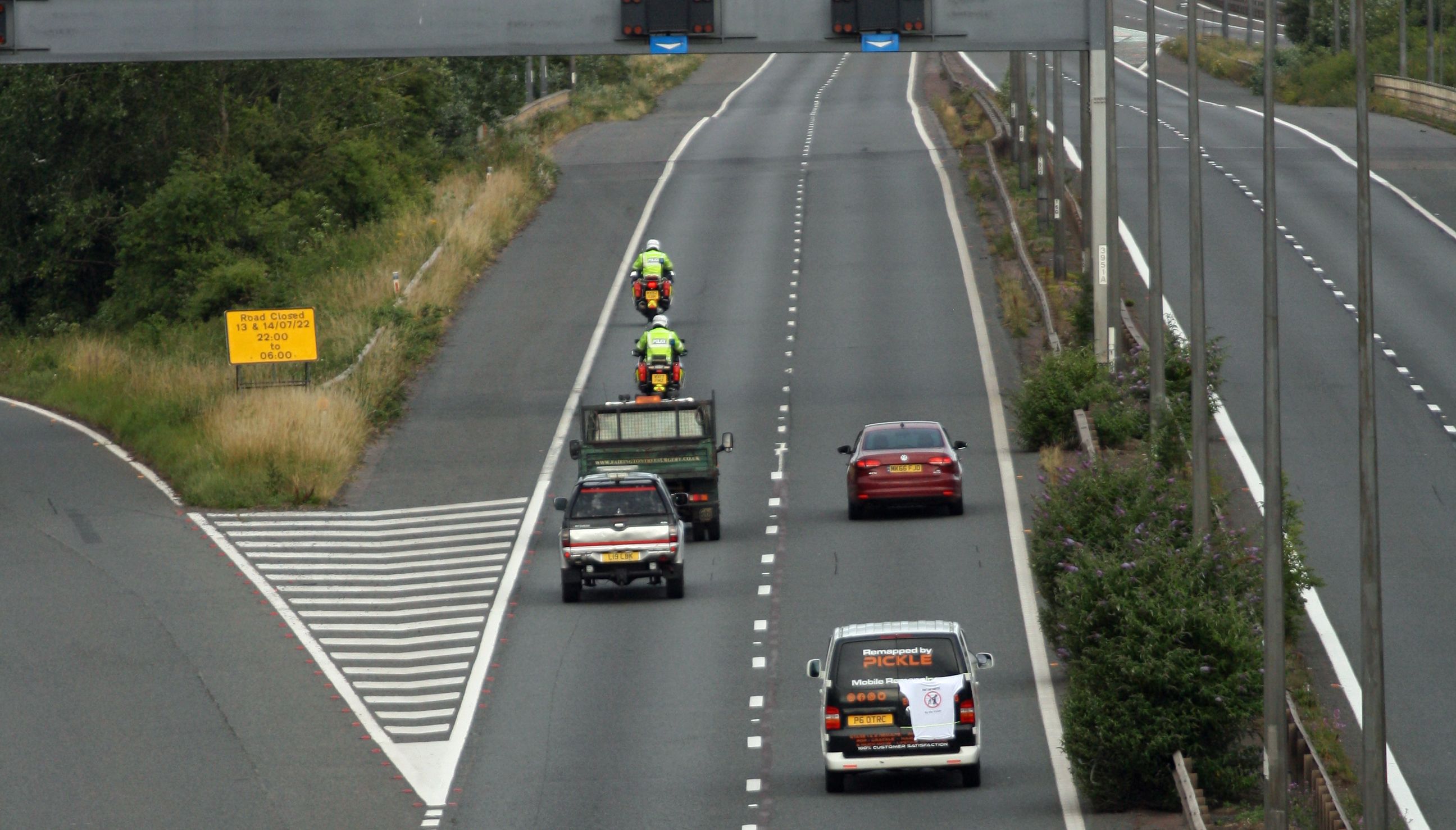 Police escort vehicles along the M4 motorway during the morning rush hour as drivers hold a go-slow protest on the M4. Police have warned of %22serious disruption throughout the day%22 as protesters target motorways in a demonstration over high fuel prices. The protests are understood to be organised via social media under the banner Fuel Price Stand Against Tax. Picture date: Monday July 4, 2022.