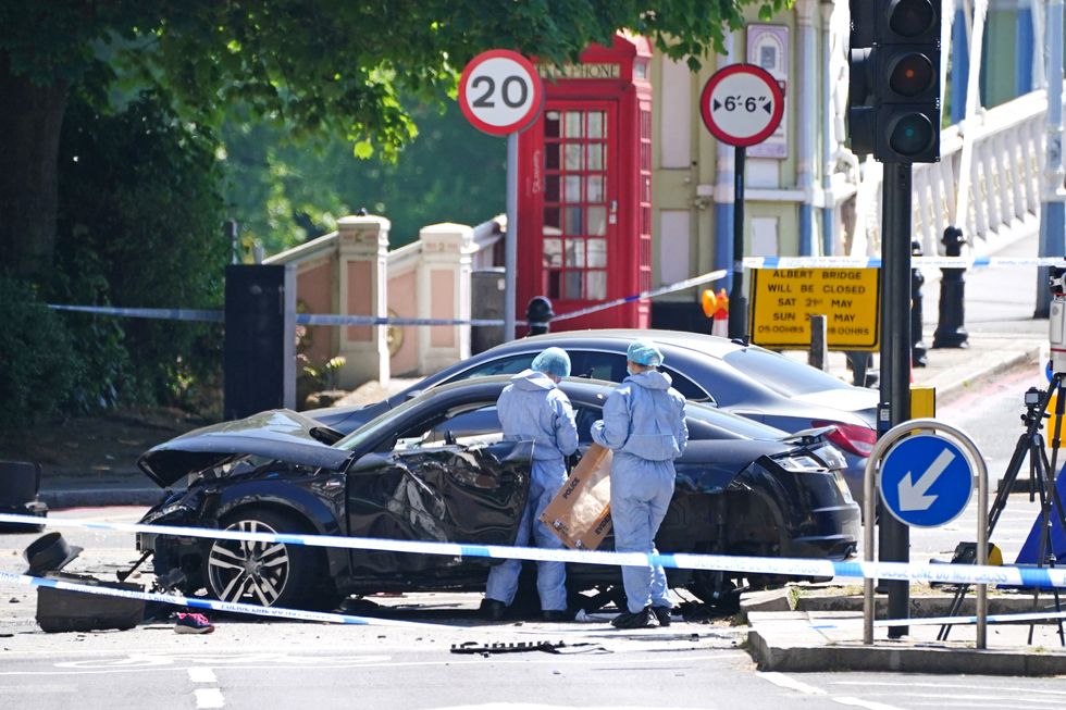 Police forensic officers at the scene at Cheyne Walk in Chelsea, London, after a 41-year-old woman and three dogs have been killed following a car crash. The driver of the car, a 26-year-old man, has been arrested on suspicion of causing death by dangerous driving and taken into custody. Picture date: Saturday May 14, 2022.