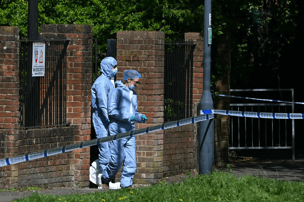 Police forensic officers work inside a cordon set up near to Kenton United Synagogue in Harrow, north-west London on April 19, 2026, the scene of an arson attack overnight.