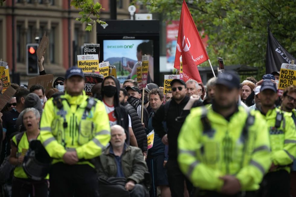 Police form a divide between people taking part in an anti-racism counter protest\u200b