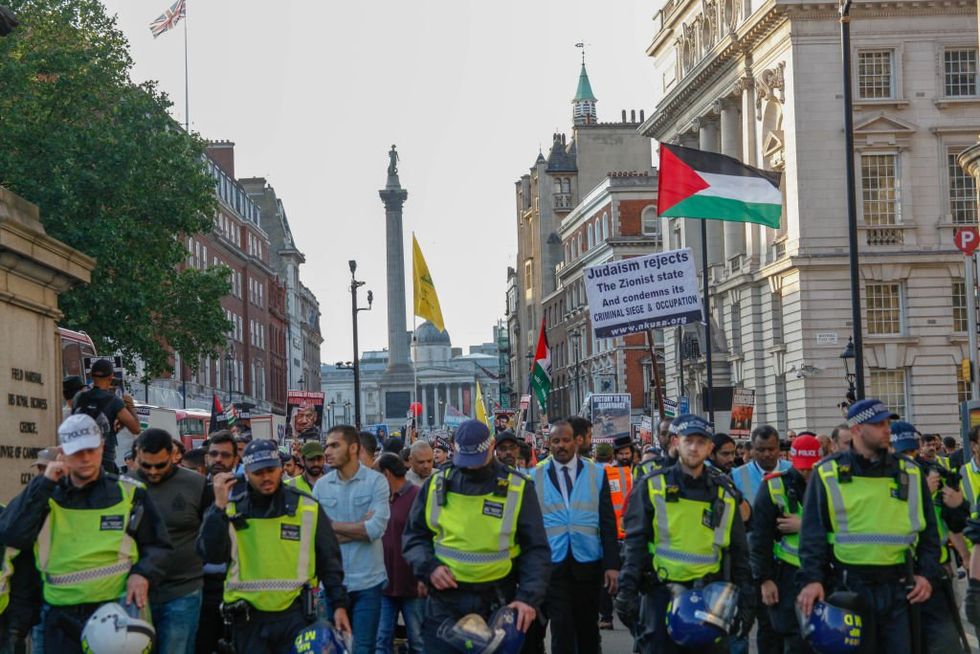 Police hold back Palestinian crowd at the Annual Al-Quds March in London, UK, on 10 June 2018\u200b