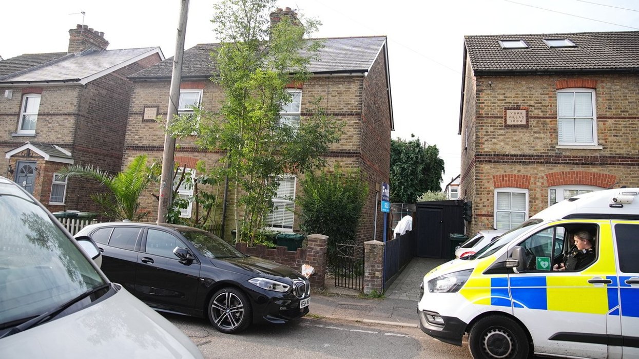 Police in Bremer Road, Staines-Upon-Thames near a property where three children and a man were found dead