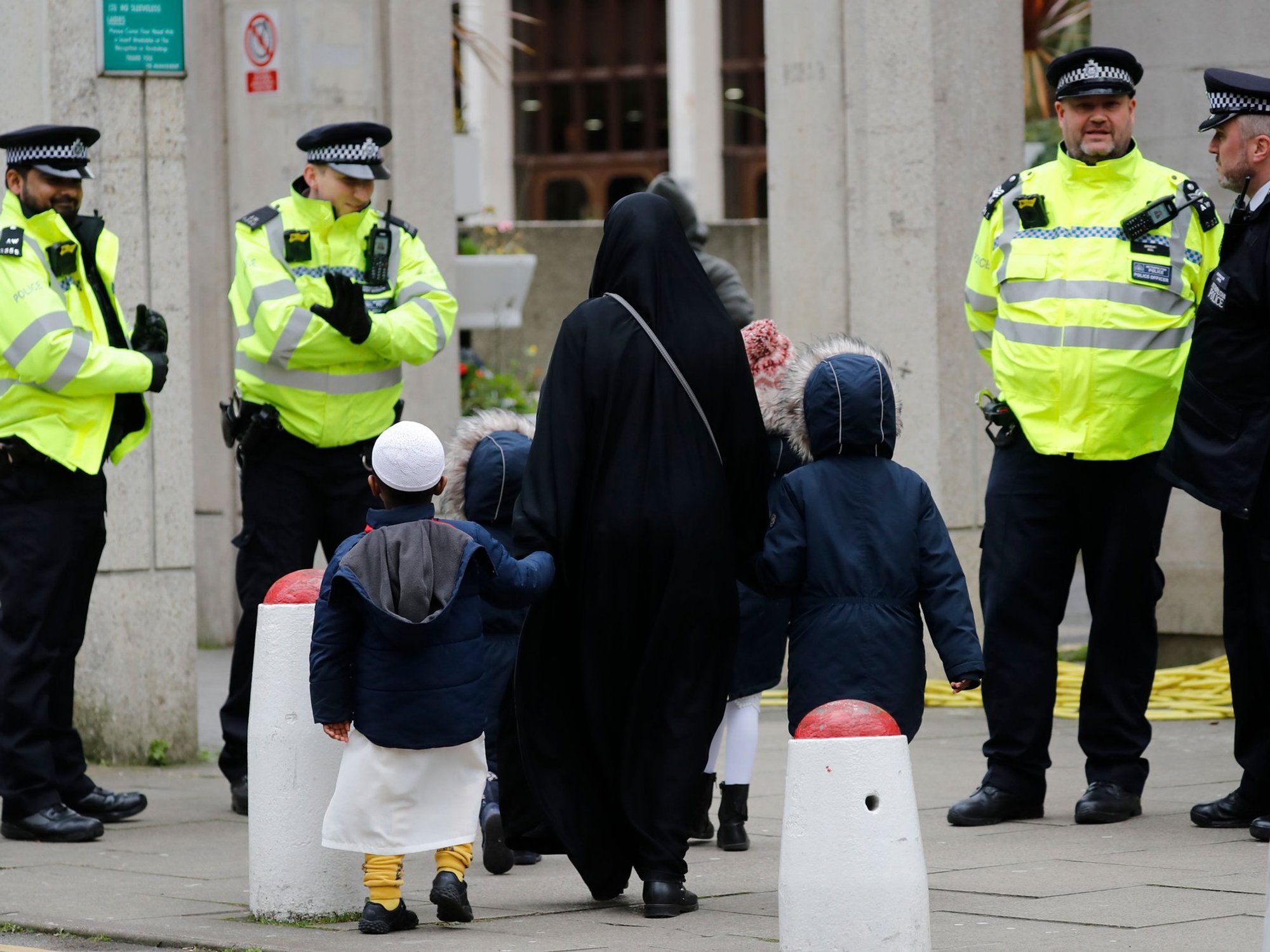 Police in London watch as a