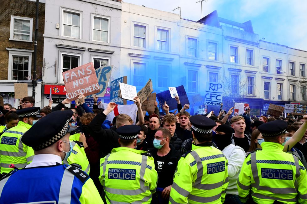 Police look on as protests take place against Chelsea's involvement in the new European Super League outside Stamford Bridge, London. Picture date: Tuesday April 20, 2021.