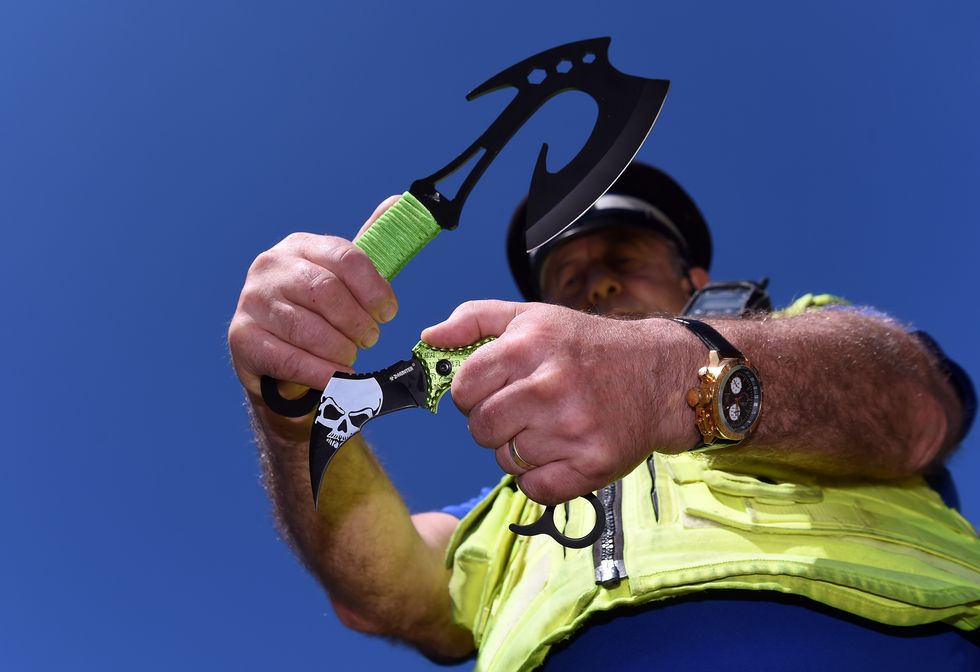 Police officer holding knives
