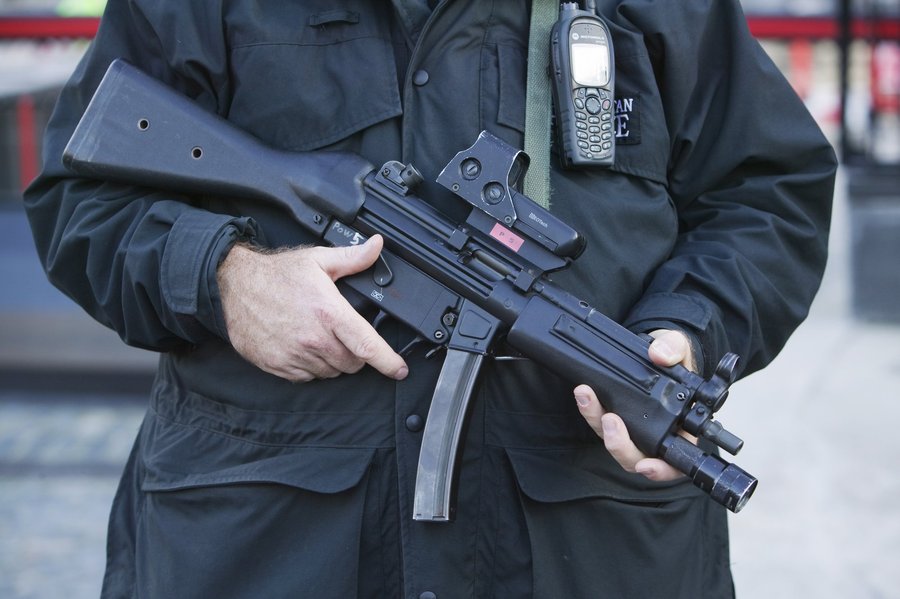 Police officer holding MP5 weapon