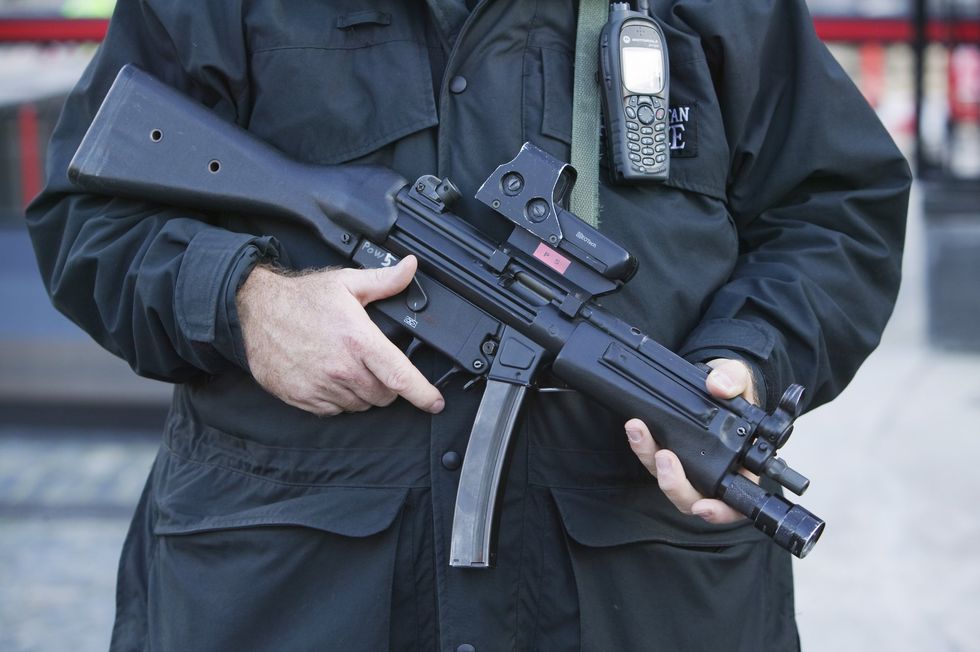 Police officer holding MP5 weapon