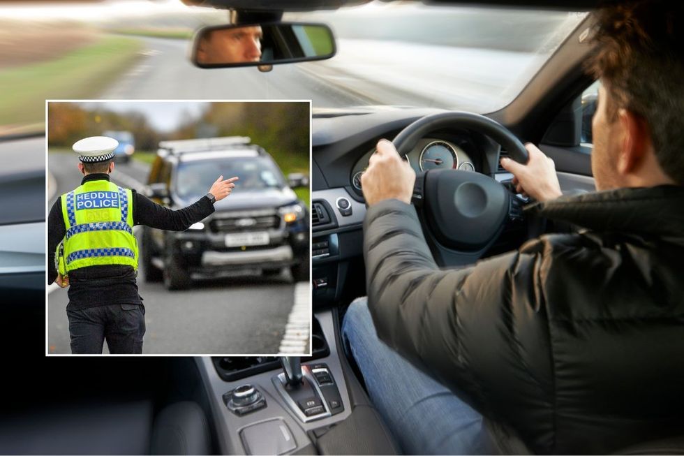 Police officer pulling a car over and a man driving a car