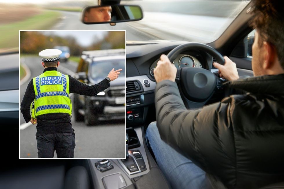 Police officer pulling a vehicle over and a man driving