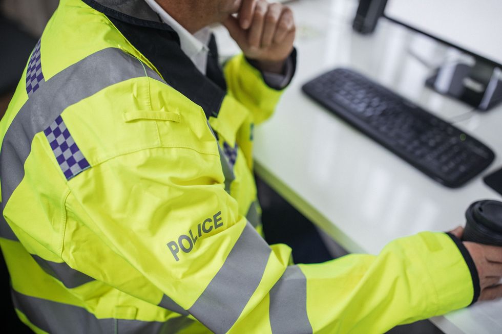 Police officer sitting at a desk