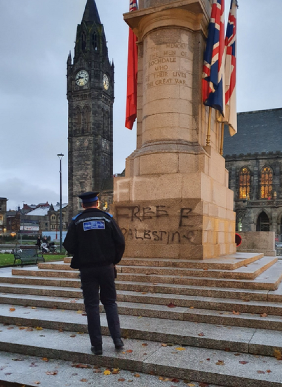 Police officer standing in front of vandalism on Rochdale Cenotaph