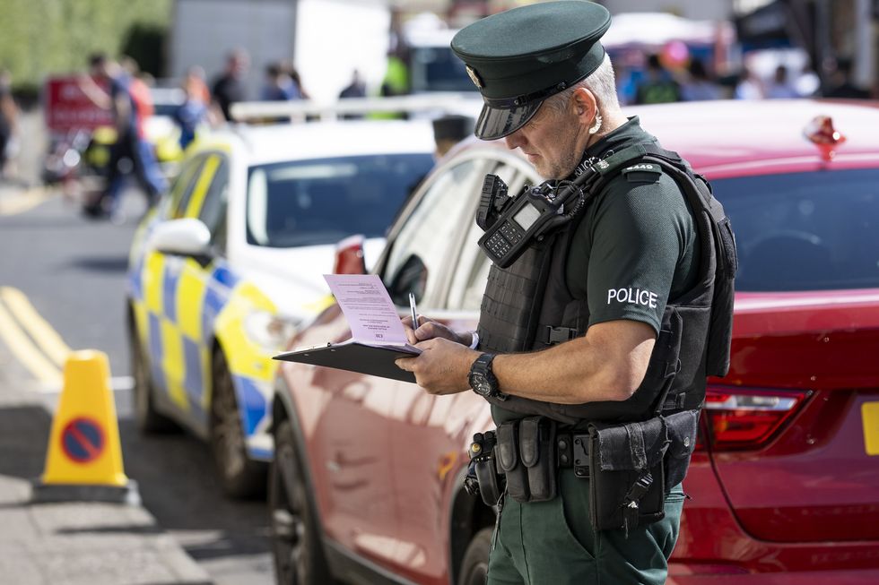 Police officer writing a parking fine