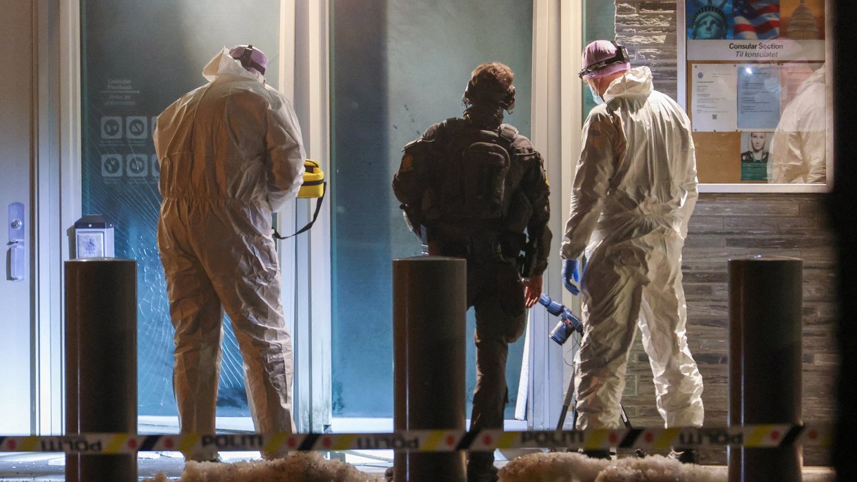 Police officers and technicians inspect the American embassy after a loud bang was reported at the site, in Oslo,