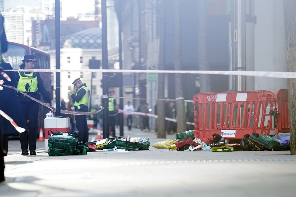 Police officers at the scene after three people have been taken to hospital following reports of stabbings at Bishopsgate in London. Picture date: Thursday October 6, 2022.