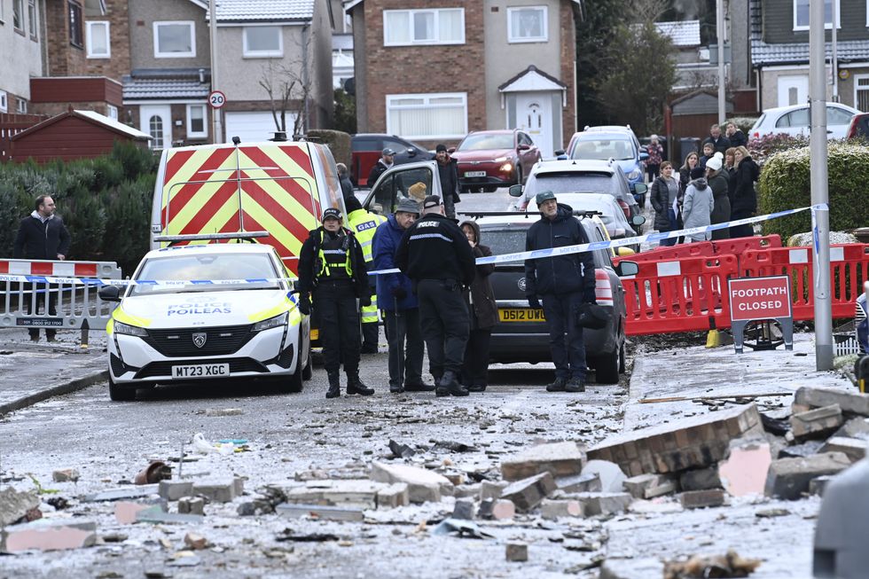 Police officers at the scene on Baberton Mains Avenue, Edinburgh, after an 84-year-old man has died following an explosion at a house on Friday night