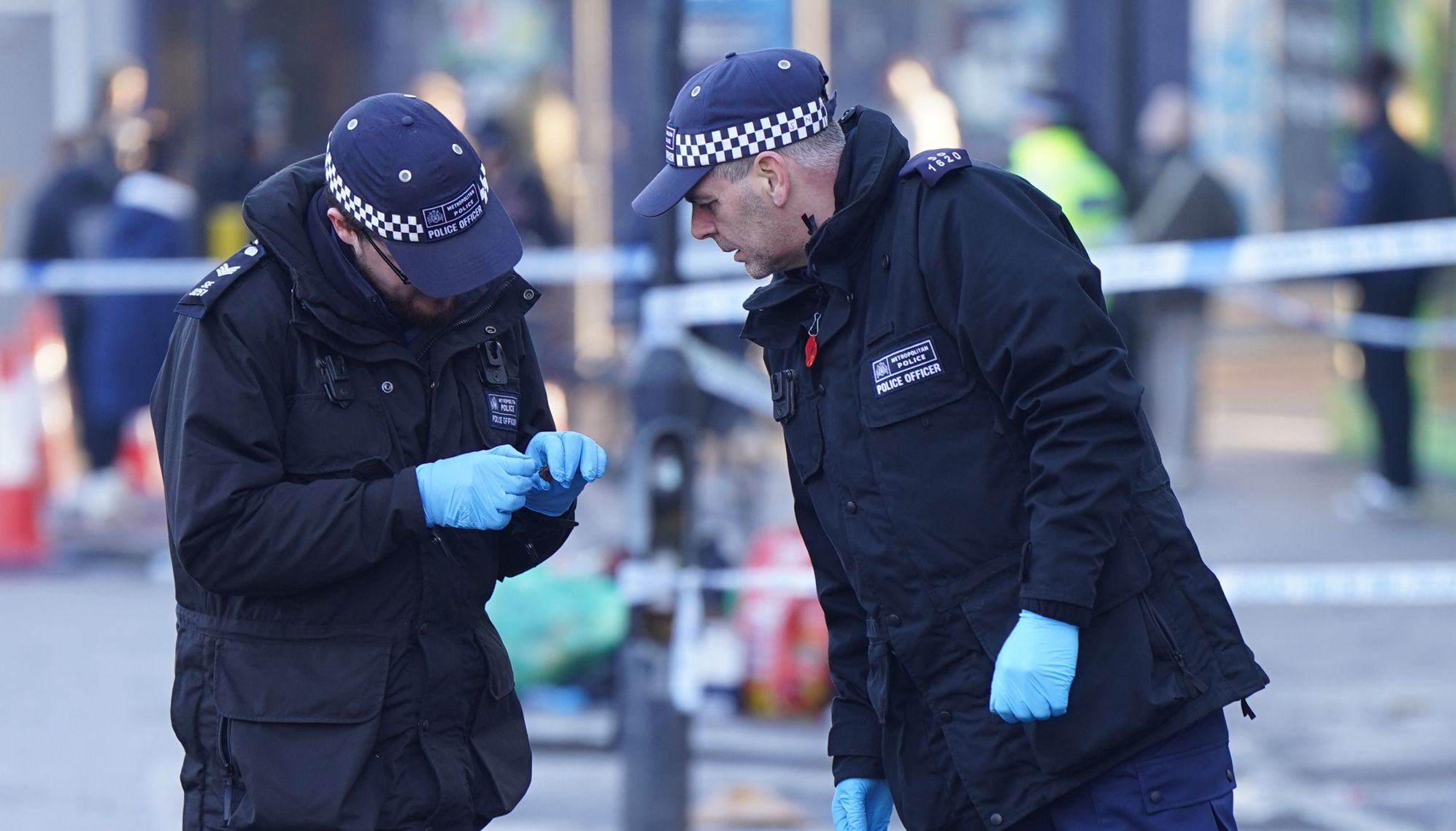 Police officers at the scene outside Brixton O2 Academy where they are investigating the circumstances which led to four people sustaining critical injuries in an apparent crush as a large crowd tried to force their way into the south London concert venue. Picture date: Friday December 16, 2022.