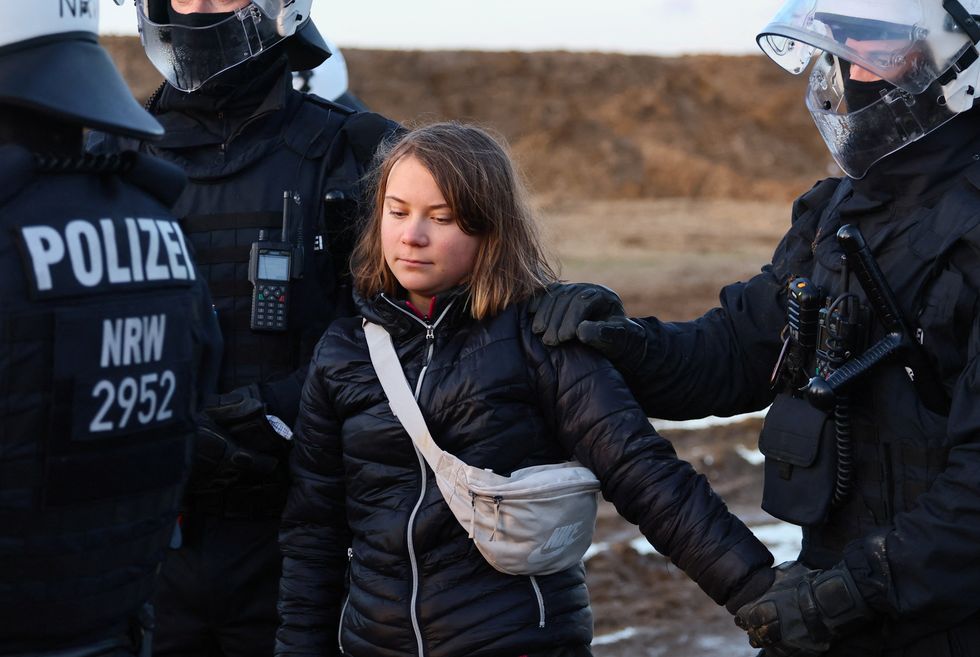 Police officers detain climate activist Greta Thunberg on the day of a protest against the expansion of the Garzweiler open-cast lignite mine of Germany's utility RWE to Luetzerath, in Germany, January 17, 2023 that has highlighted tensions over Germany's climate policy during an energy crisis. REUTERS/Wolfgang Rattay