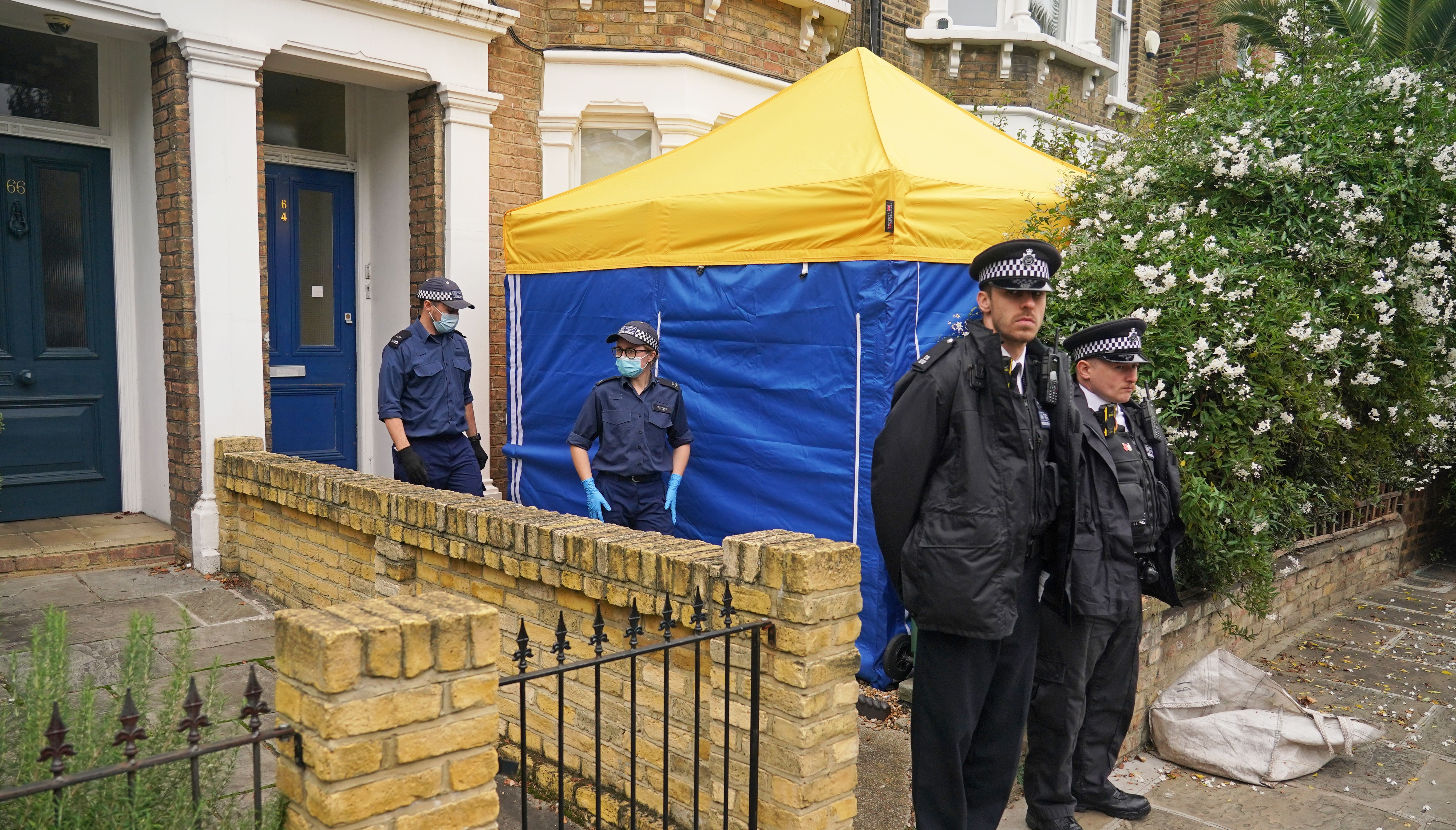 Police officers erect a tent outside a house in north London, thought to be in relation to the death of Conservative MP Sir David Amess.