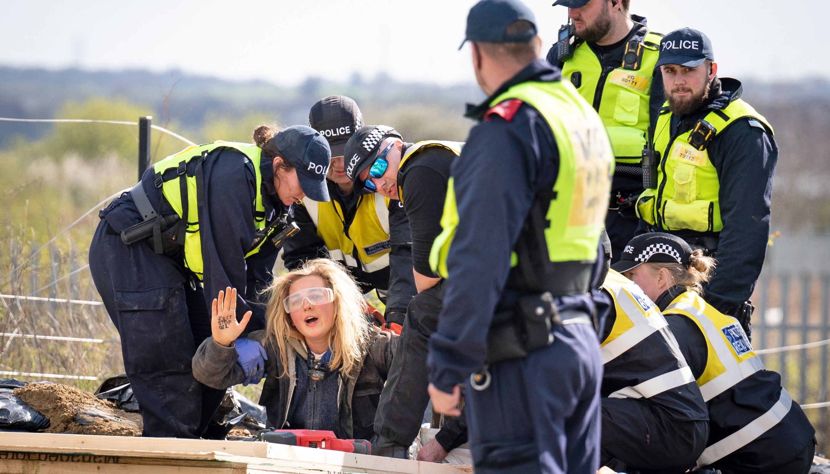 Police officers from the Protester Removal Team work to free a Just Stop Oil activist who is part of a blockade at the Titan Truck Park in Grays, Essex. Picture date: Saturday April 2, 2022.