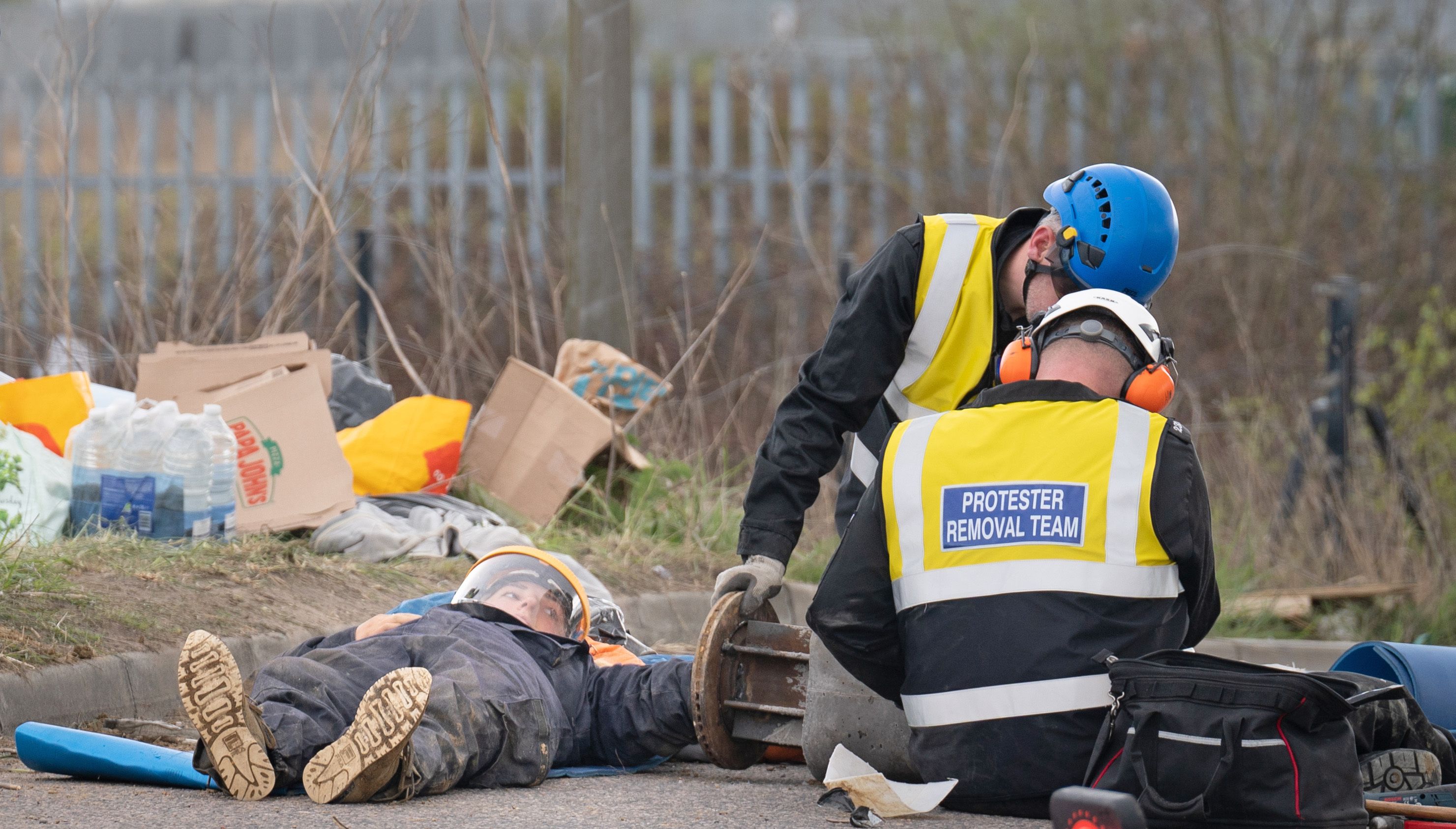 Police officers from the Protester Removal Team work to free a Just Stop Oil activist who is part of a blockade at the Titan Truck Park in Grays, Essex. Picture date: Saturday April 2, 2022.