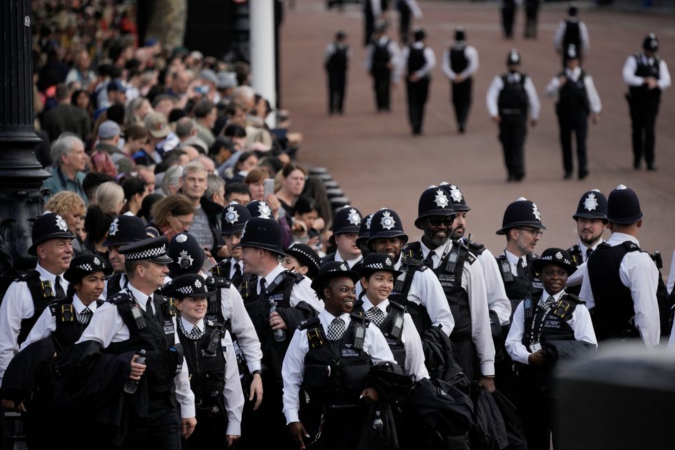 Police officers gather outside Buckingham Palace from where the coffin of late Queen Elizabeth II will depart in procession to Westminster Hall in London, Wednesday, Sept. 14, 2022.  Vadim Ghirda/Pool via REUTERS