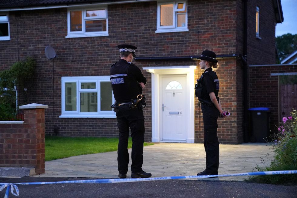 Police officers in front of Sara's home in Woking