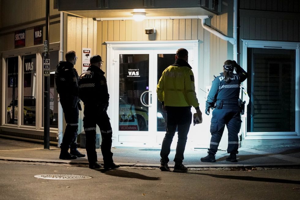Police officers investigate after several people were killed and others were injured by a man using a bow and arrows to carry out attacks, in Kongsberg, Norway, October 13, 2021.