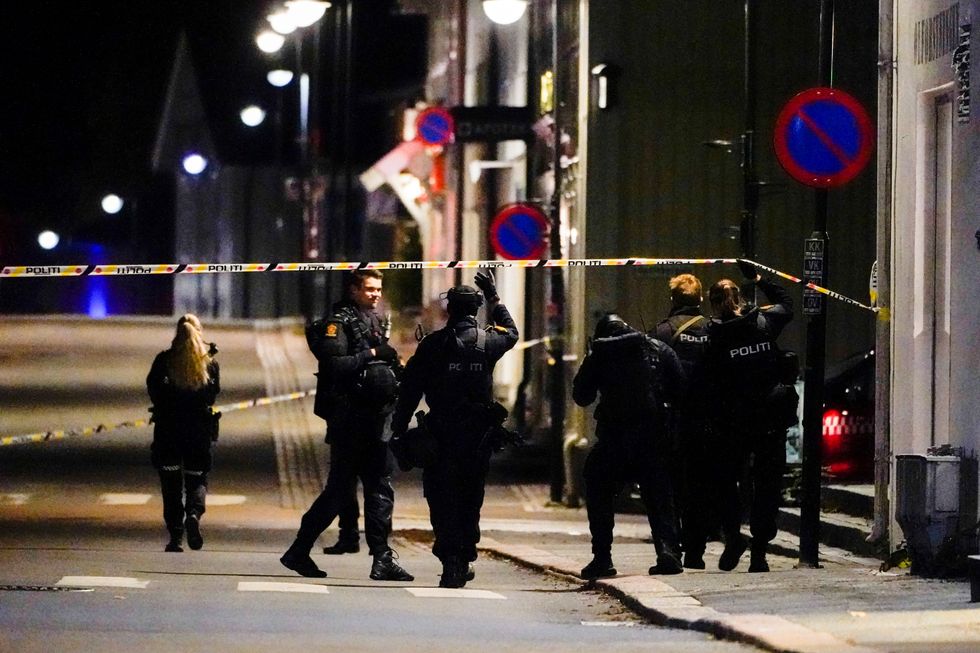 Police officers investigate after several people were killed and others were injured by a man using a bow and arrows to carry out attacks, in Kongsberg, Norway, October 13, 2021..