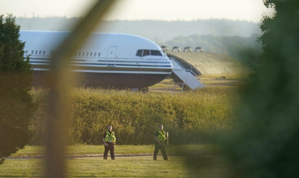 Police officers near the Boeing 767 aircraft at MoD Boscombe Down, near Salisbury