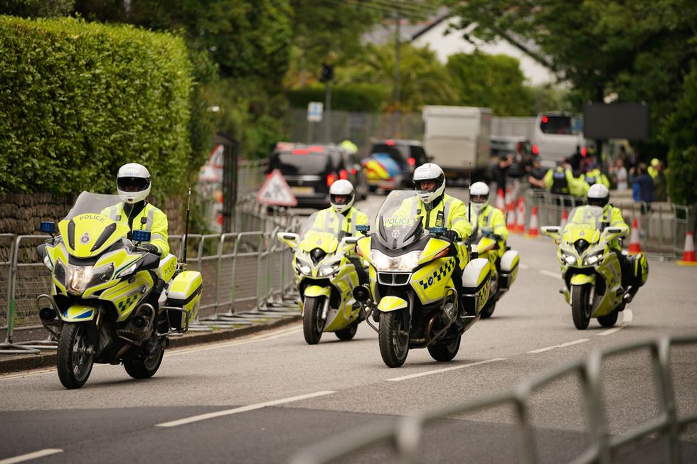 Police officers on motorcycles patrol through Carbis Bay in Cornwall.