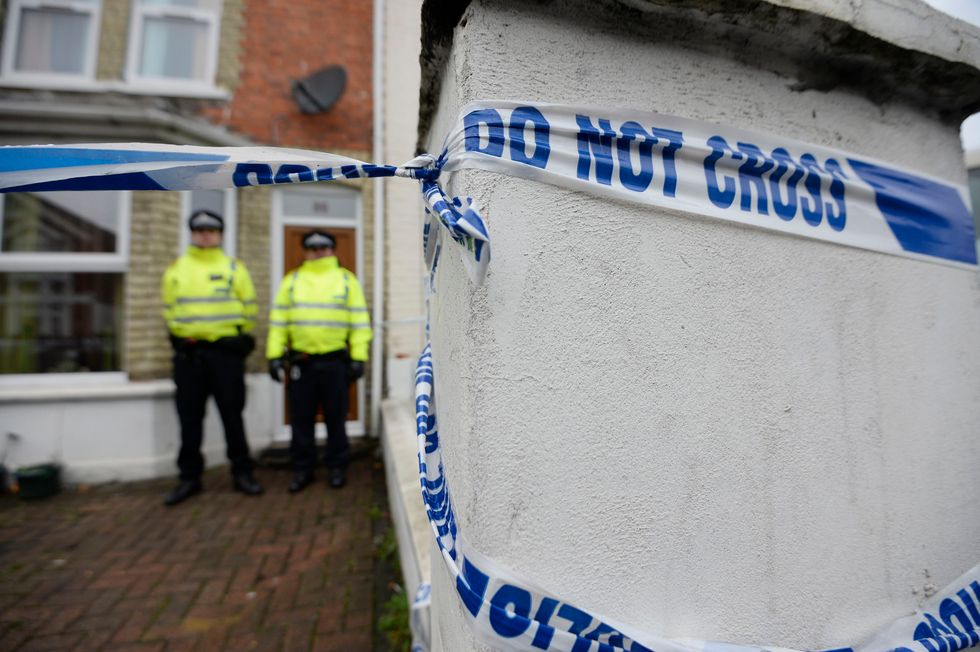 Police officers outside a house where four men were arrested in connection with an alleged Islamist terror plot.