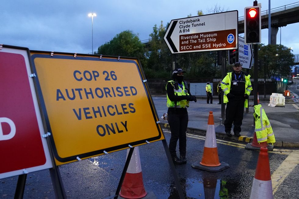 Police officers patrol a roadblock in the centre of Glasgow at the start of the Cop26 summit in the city.